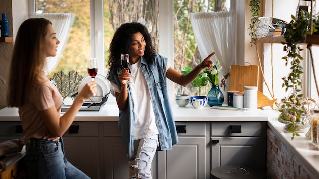 Free photo two female friends together in the kitchen