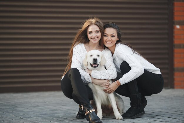 Two female friends with dog