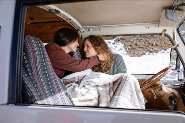 Бесплатное фото Две любовницы просыпаются в автофургоне во время зимней поездки