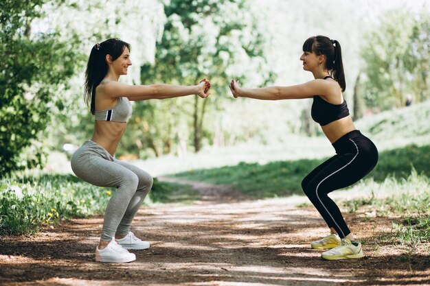 Two fit girls stretching in park