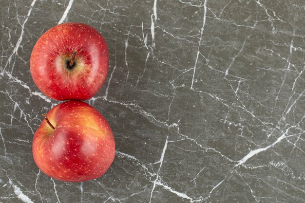 Two fresh apple on grey stone.