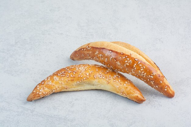 Two fresh delicious croissant on white background