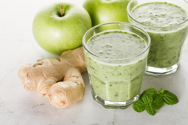 Two fresh green smoothies with ginger