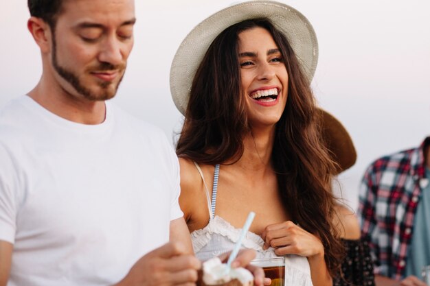 Two friends at a beach party