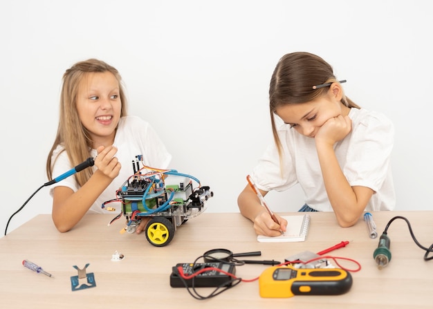 Two friends doing science experiments with robotic car