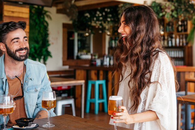 Two friends laughing in bar