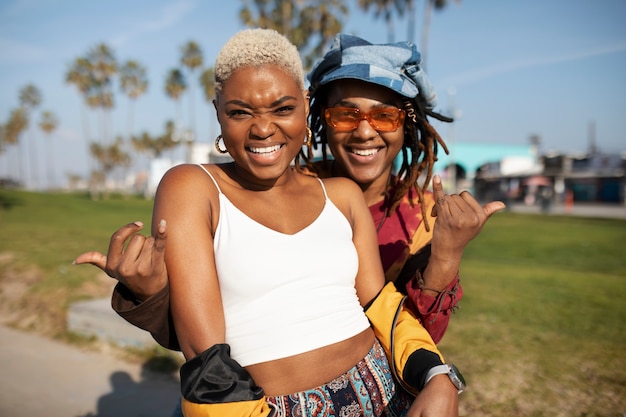 Free photo two friends posing outside in the park