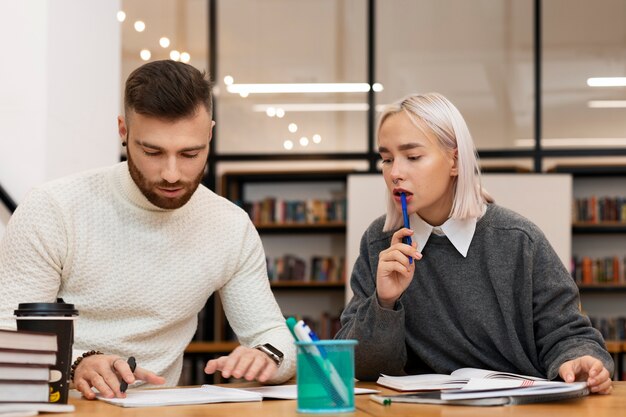 Two friends reading from a notebook during study session