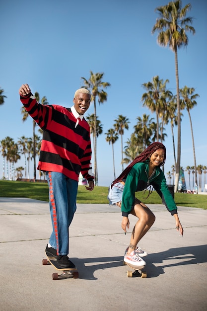 Two friends riding their skateboards outside in the park