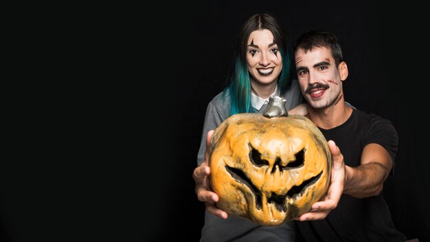 Two friends with creepy makeup with Jack-O-Lantern