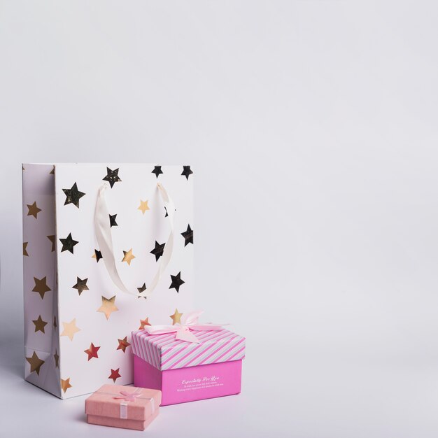 Two gift boxes and shopping paper bag on white background