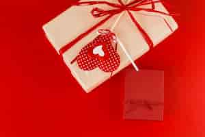 Free photo two gift boxes with heart on table