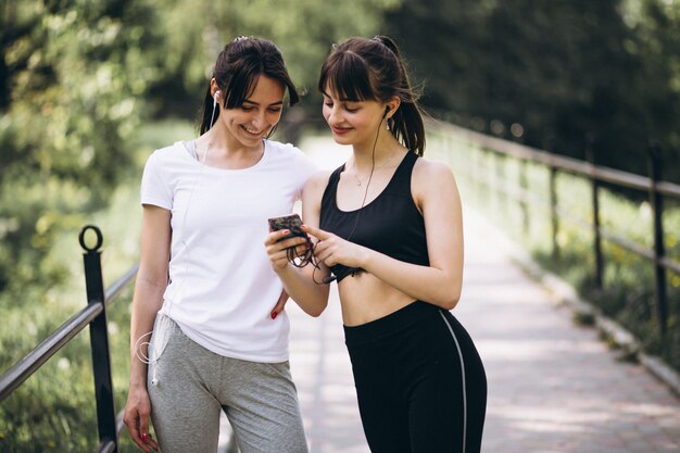 Two girl walking in park after exercising