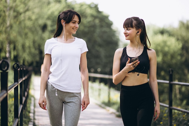 Two girl walking in park after exercising