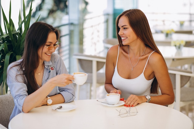 Two girls at cafe having tea