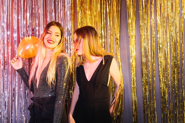 Two girls dancing at new year party