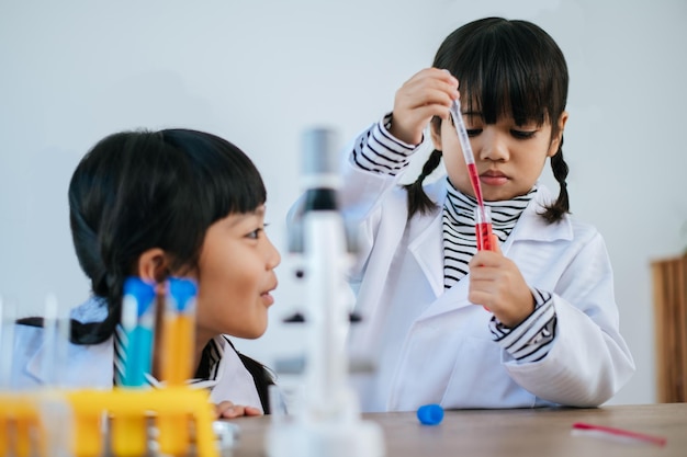 Due ragazze che fanno esperimenti scientifici in un laboratorio. messa a fuoco selettiva.