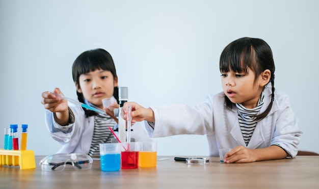 Two girls doing science experiments in a lab. Selective focus.