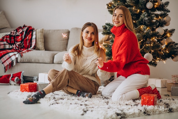 Two girls friends celebrating christmas