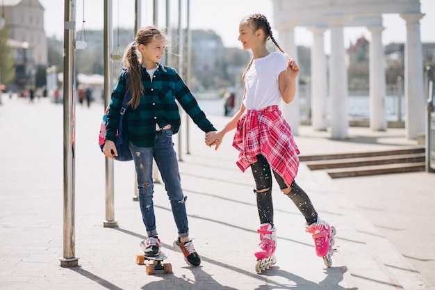 Free photo two girls friends roller skating