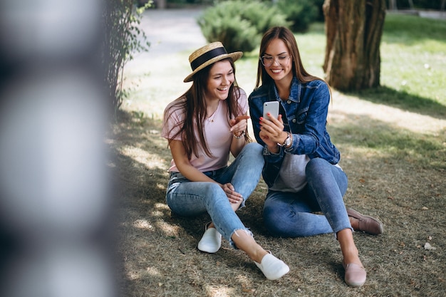 Free photo two girls friends sitting in park