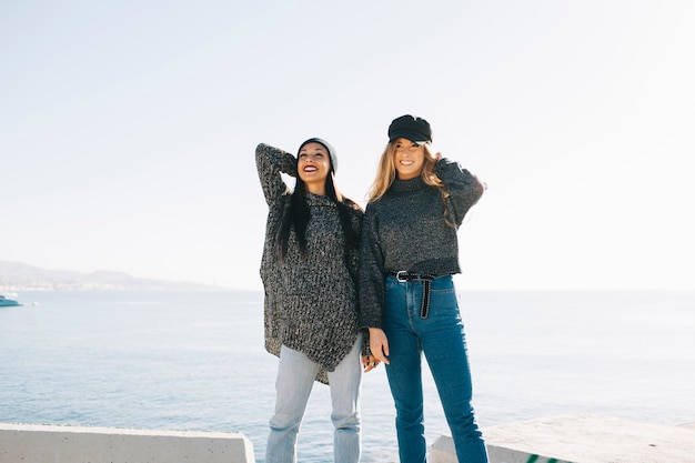 Two girls in front of sea