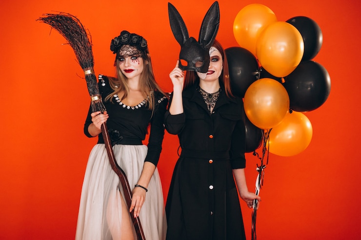 Free Photo two girls in halloween costumes