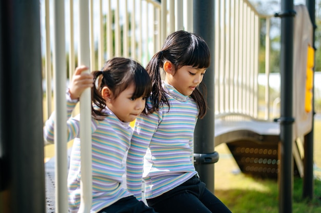 Free Photo two girls happily playing in the playground