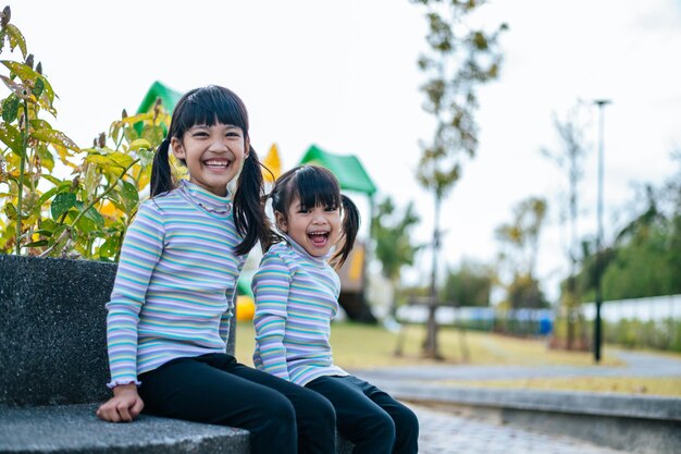 Two girls happily playing in the playground