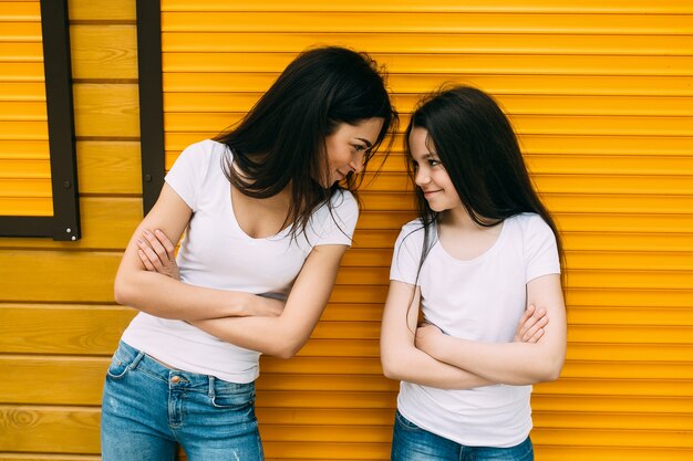Two girls holding arms crossed staring