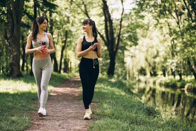 Two girls jogging in park
