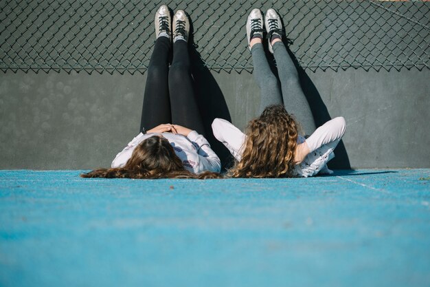 Two girls lying on rooftop