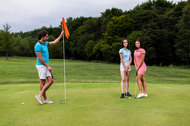 Two girls and a man posing for a photo