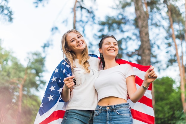 Two girls in nature with american flag