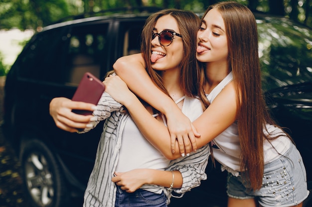 Free photo two girls near car