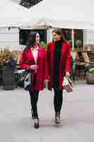 Foto gratuita due ragazze in modelli di cappotti rossi