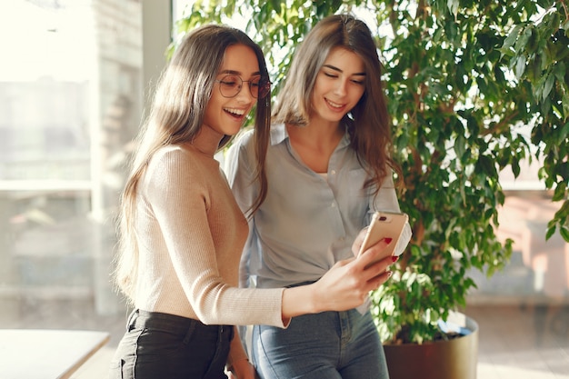 Two girls standing at the cafe