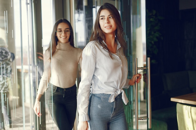 Two girls standing at the cafe