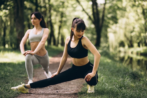 Two girls stretching in park