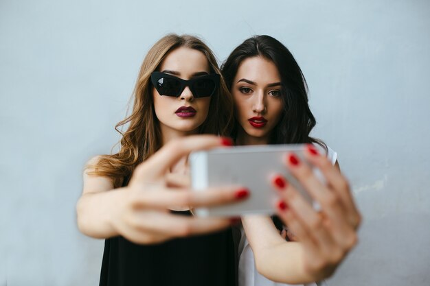 Two girls taking a photo with the mobile