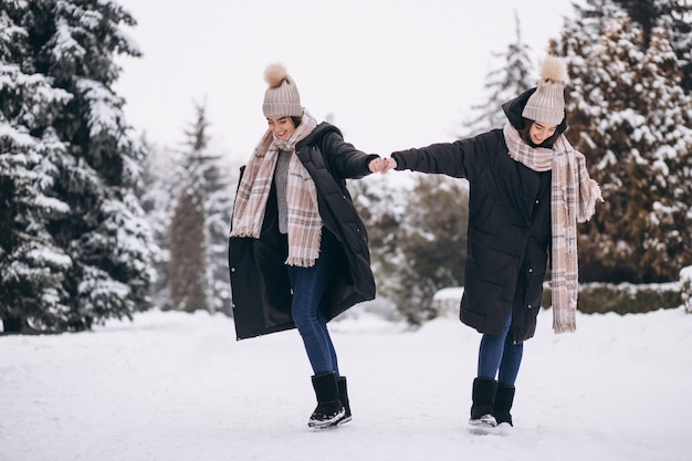 Two girls twins together in winter park