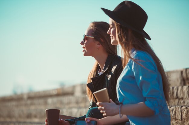 Two girls walking with shopping on city streets