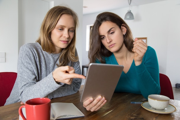 Two girls watching presentation on mobile pc