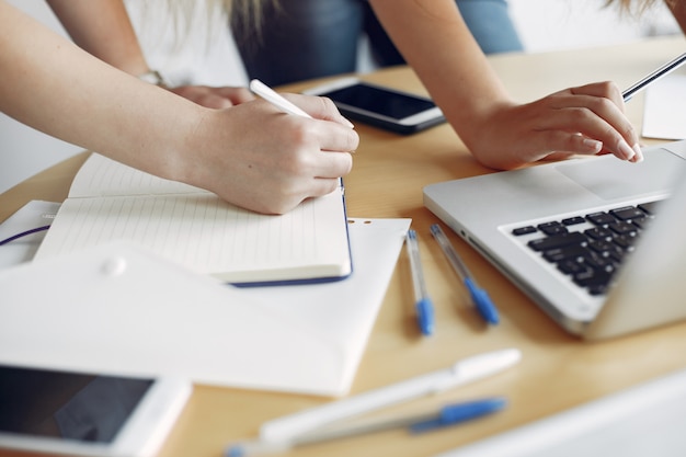 Two girls in a white t-shirts working at the office