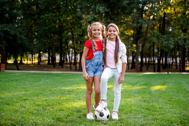 Two girls with football ball outdoor