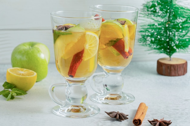 Two glass of apple cocktail with fresh apple and cinnamon. 