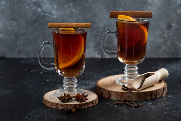 Two glass cups with fresh tea and cinnamon sticks.