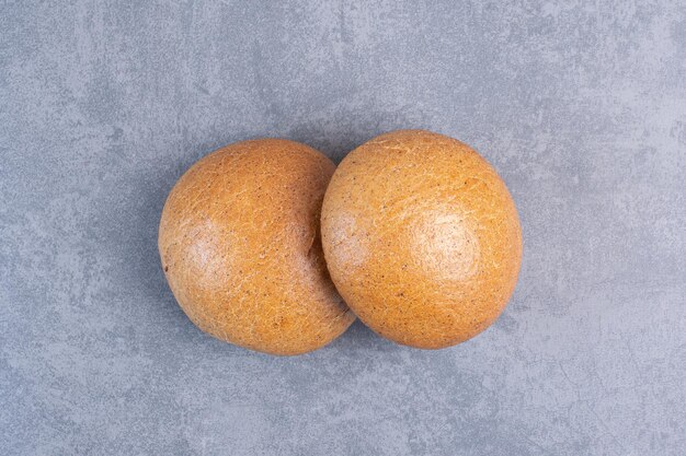 Two hamburger buns on marble background. High quality photo
