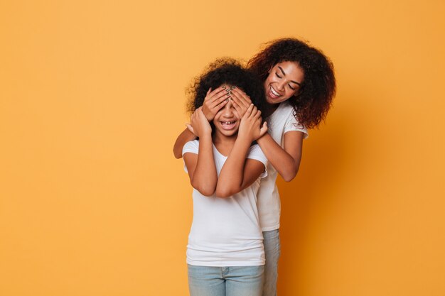 Two happy afro american sisters having fun