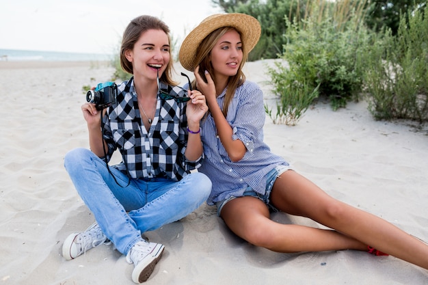 Two happy female friends having fun on beach